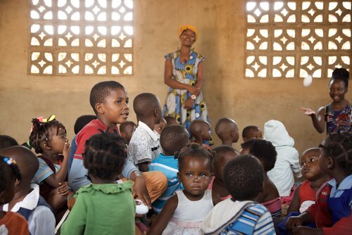 Children learning in classroom with carers