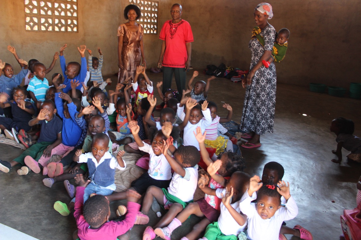 Children with hands raised excitedly